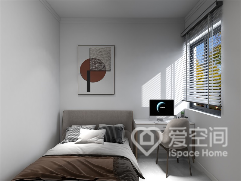 次卧的背景墙是空间的亮点，装饰画和办公桌椅都提升了空间的功能感。