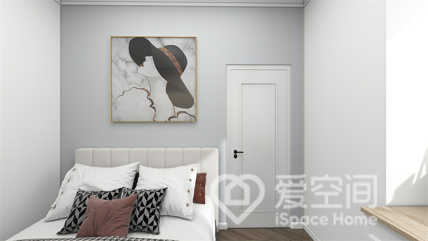 次卧以素色背景打底，辅以优雅装饰画点缀，艺术魅力油然而生，加上干净的单人床布置，营造出一种温馨的氛围。